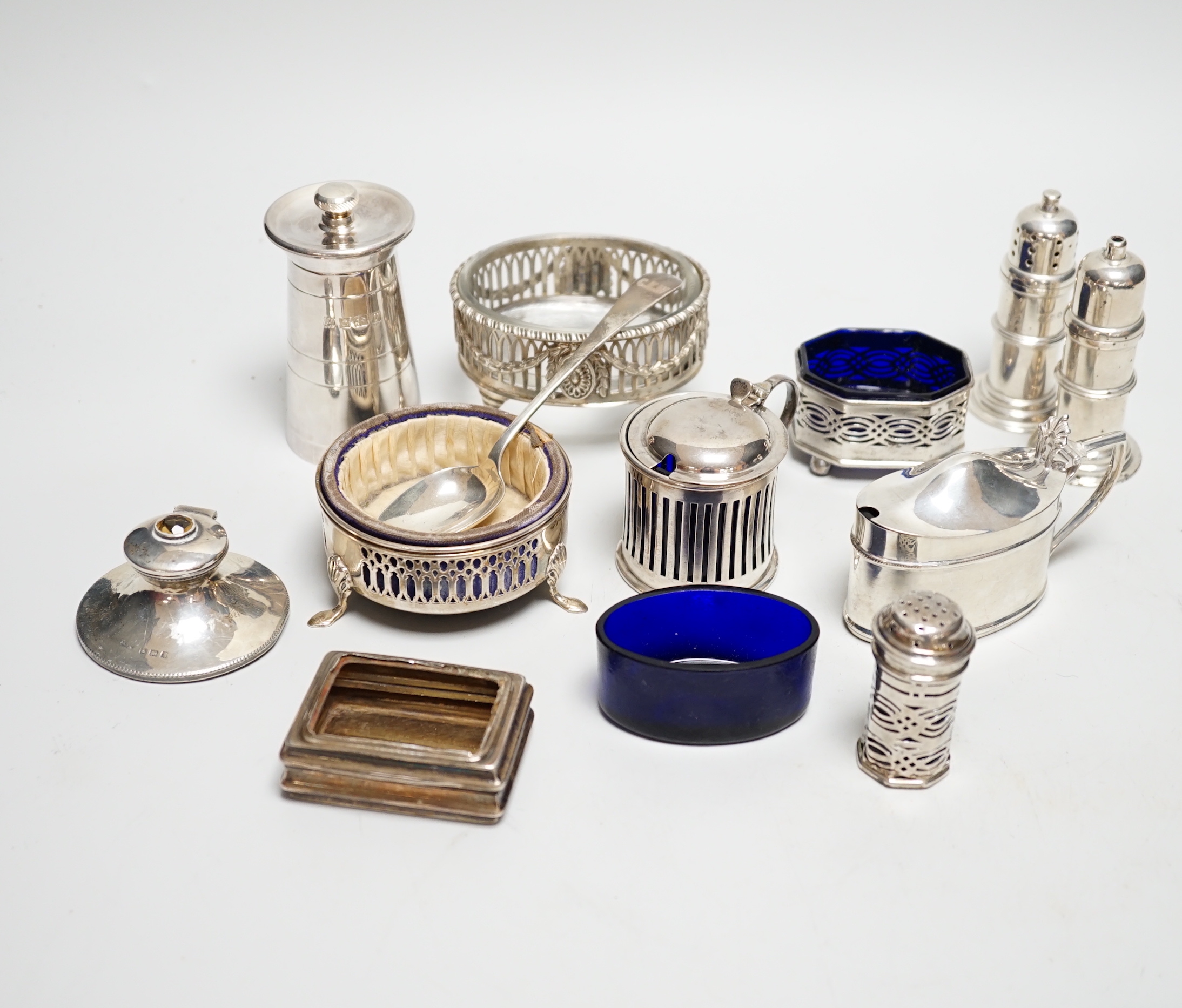 Eight assorted silver condiments, including a George III oval salt and four other items including small inkwell.